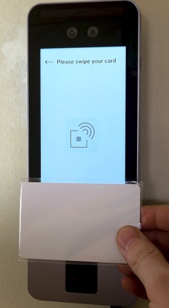 An employee swiping a card against the bt505's sensor.